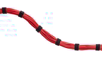 A bundle of red cables held together with a series of ties.