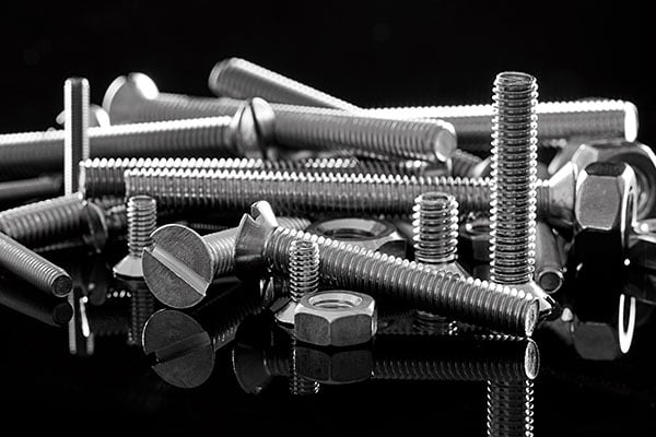 Closeup on an assortment of bolts, nuts, screws and washers.