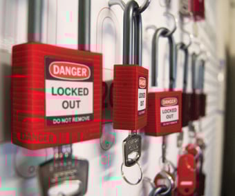 Brady padlocks with &quot;DANGER LOCKED OUT&quot; labels hang on a shadow board.