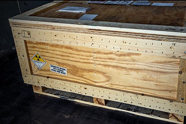 Large wooden crate with a radioactive warning label.