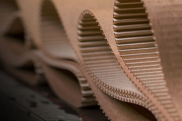 Extreme closeup of rolled cardboard revealing paper fibers within.