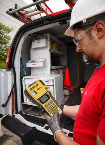 Tech using the Brady BMP41 label printer.
