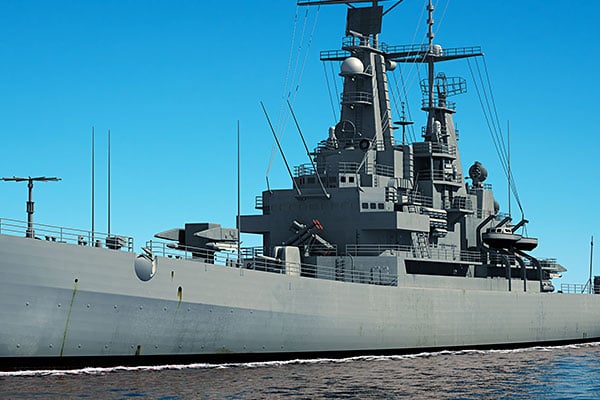 Battleship with open blue sky behind it. 