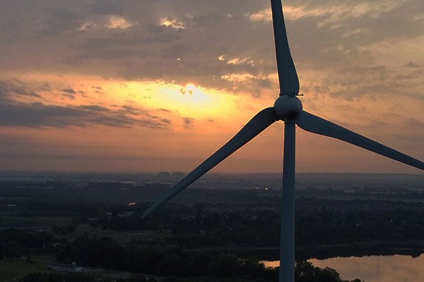 Horizon with wind turbine at sunset or sunrise.