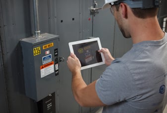 A safety worker taking a photo of a lockout point for use in a LINK360 procedure.