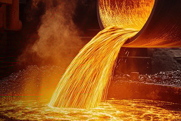 Closeup of orange and red molten metal being poured.