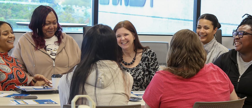 women at a conference room table