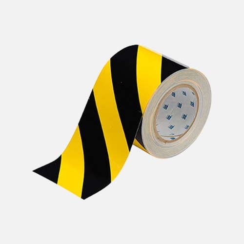 a roll of black and yellow stripped floor tape