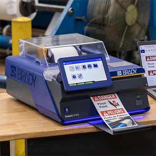 Brady J7300 printer printing a label on a table