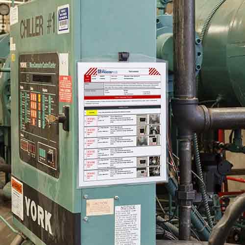 printed LINK360 procedure guide on the side of a control panel