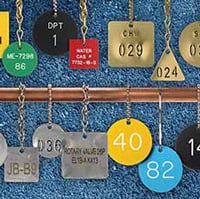 A collection of different metal and colored plastic valve tags.