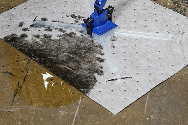 A Brady Handysorb pad soaking up a spill