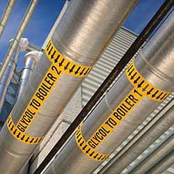yellow brady pipe labels on metal boiler piping