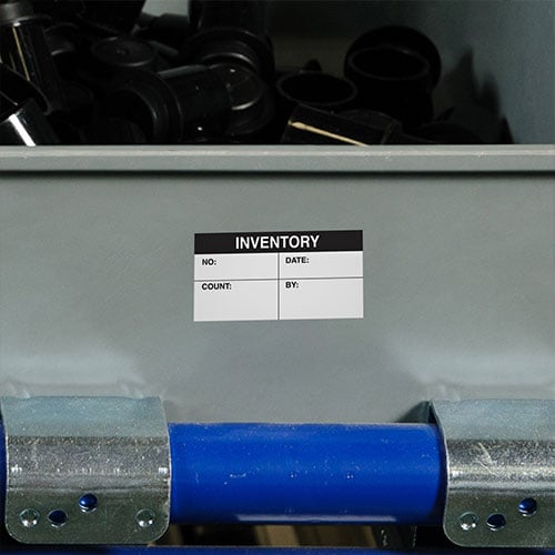 An inventory label on a plastic bin