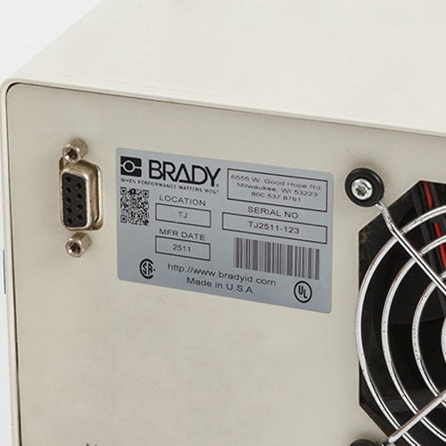 A metallic label on a metal fan
