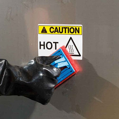 A sponge cleaning a wall with a washdown label on it