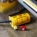 Brady 3-in-1 plug lockout with red padlock attached.