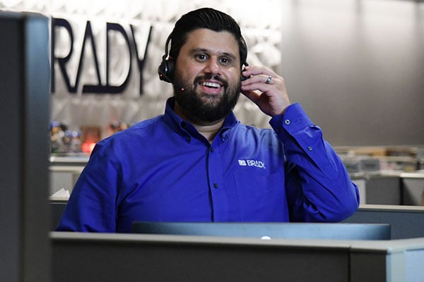 Customer service rep talking on the phone to a Brady customers