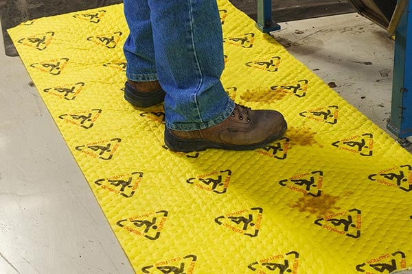 Person standing on a BrightSorb absorbent pad.