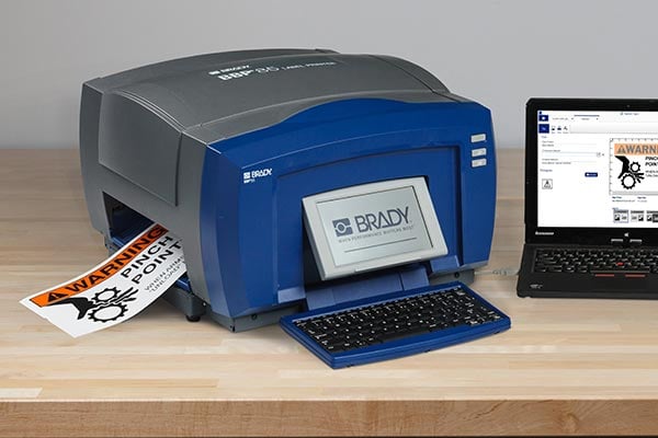 Brady printer printing warning label.