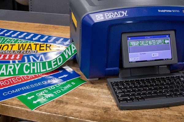 A brady printer with a selection of pipe marker labels