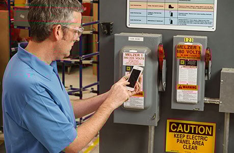 an electrical worker taking a photo of an electrical panel