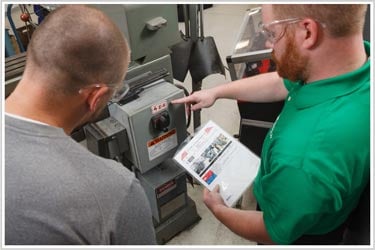 Service Engineers reviewing compliance infomation