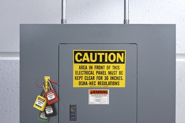 A caution sign on an electrical panel