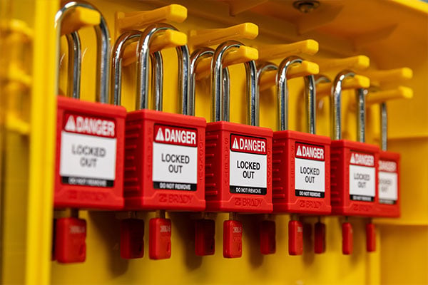 a series of 6 red padlocks on a LOTO hanger