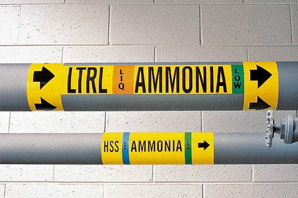 a yellow LTRL Ammonia banner on a factory pipe