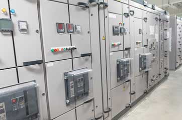 A row of large, gray electrical control panels.