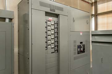 A large electrical panel with circuit breakers visible.