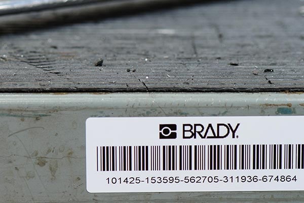 Closeup of a Brady barcode label on a metal surface.