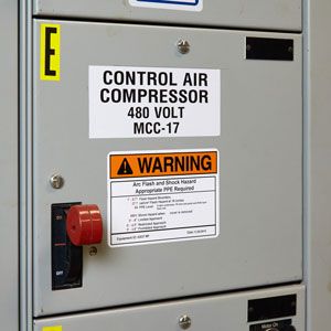 Warning labels on an electrical panel.