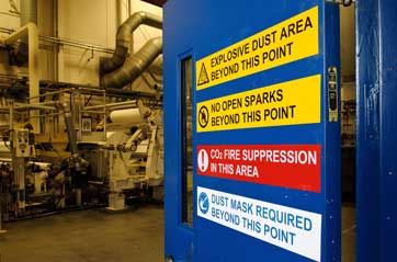 Industrial door with safety warning signs.