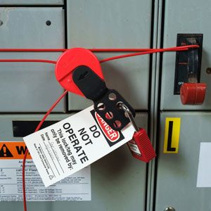 Electrical panel with a Brady cable lockout and safety tag.
