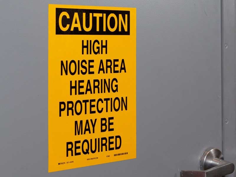 Sign on a boiler room door warning about noise hazards.