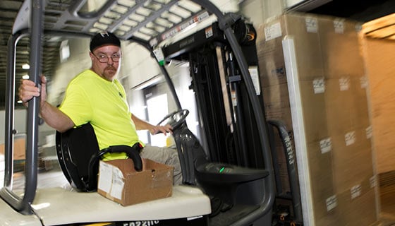 A worker operating a forklift.