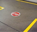 Stop sign floor marker at the end of an aisle.