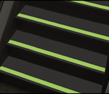 Stair treads marked with glow-in-the-dark floor tape.