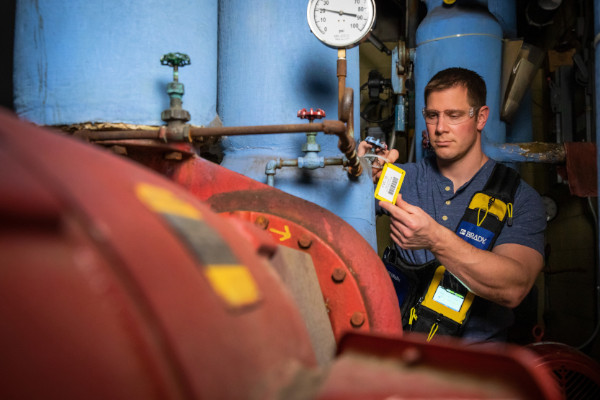 Employee inspecting a valve lockout tag.