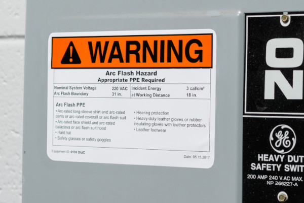 An arc flash warning label on an electrical box.