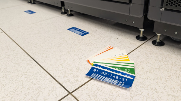 Server rack ID labels fanned out on the floor in front of server racks.