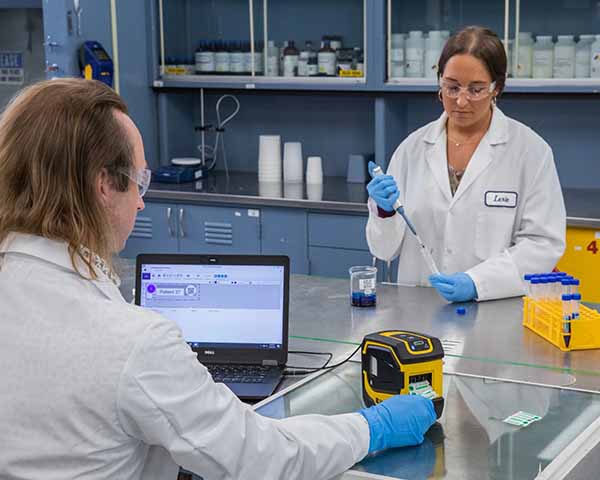 Technicians use a label printer to print and label samples.