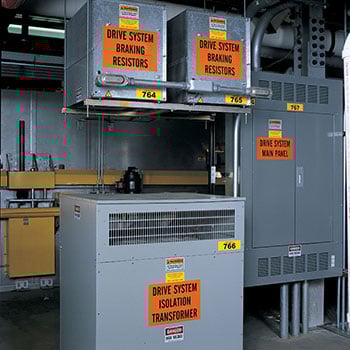 A collection of electrical boxes with orange labels.
