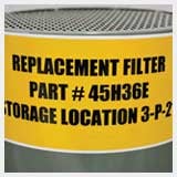 A filter with label reading replacement filter and part number.