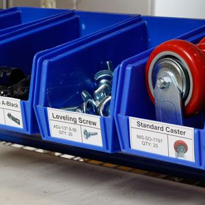 Small blue plastic storage bins with inventory labels.
