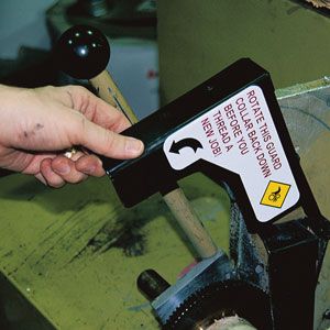 Closeup of a  Brady machine guard label.