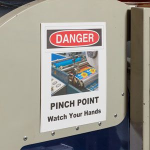 A pinch point warning label.