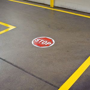 A stop sign on the floor in an industrial setting.